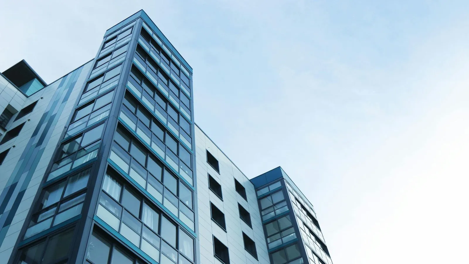 Modern glass office building against a clear sky